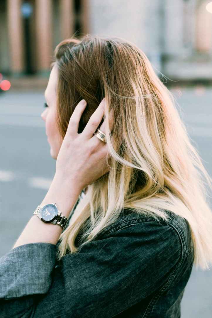 brown haired woman holding her hair
