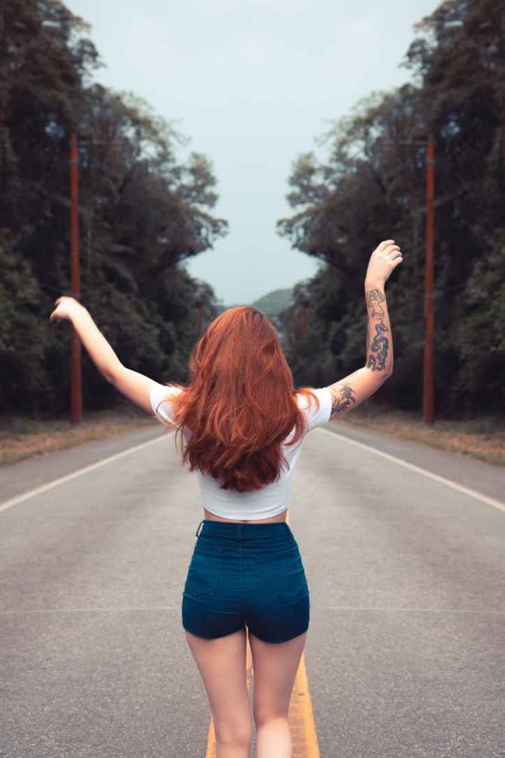 photo of woman raising her hands