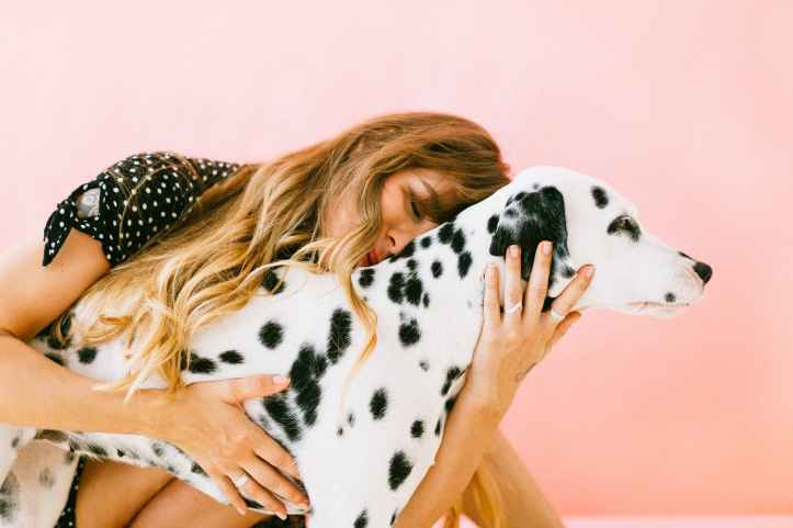 woman hugging adult dalmatian