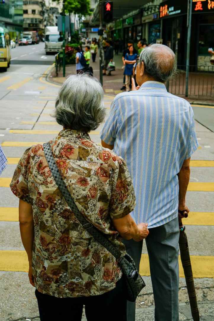 man and woman standing beside pedestrian lane