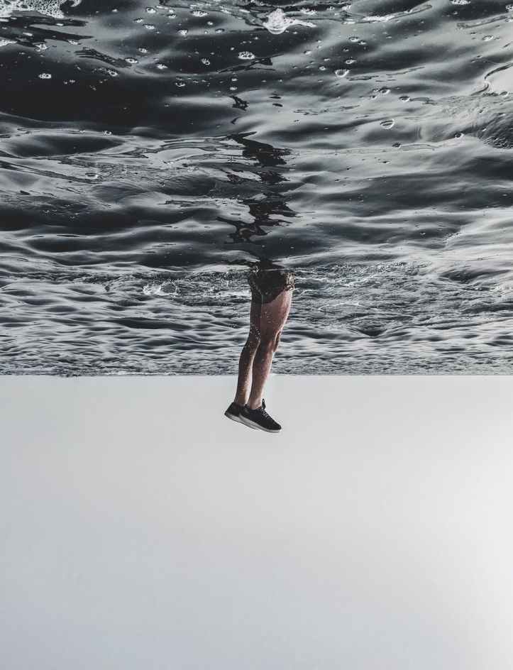 person diving on body of water