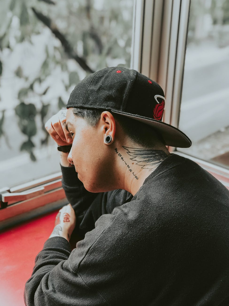man leaning near glass windows