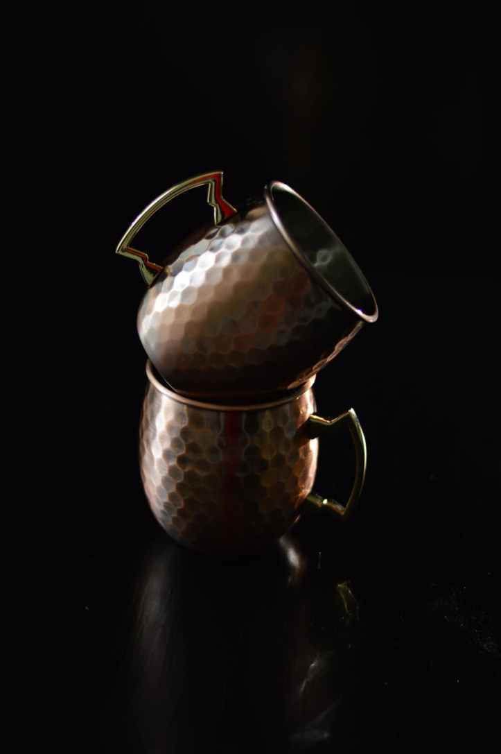 tow brass mugs stack on top