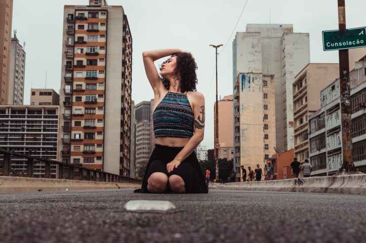 low angle photo of woman posing on street
