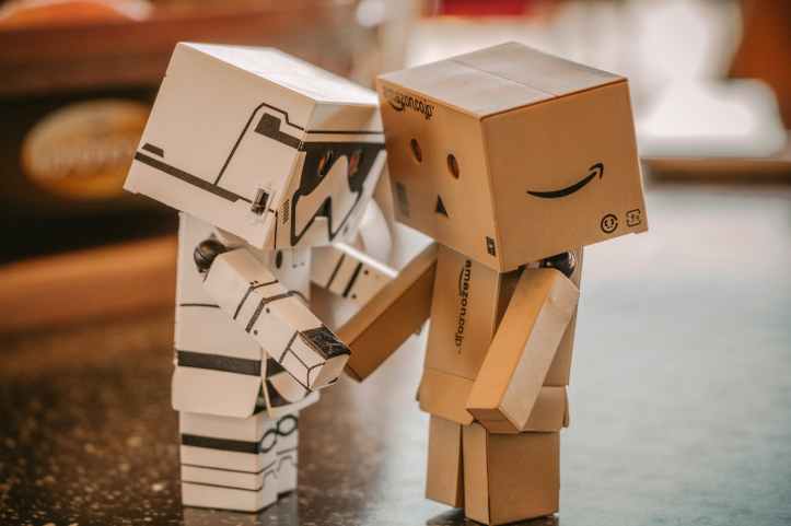 photo of white and brown cardboard box toy figure