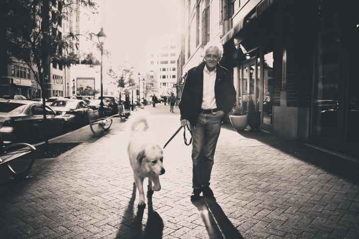 man dog streets walking