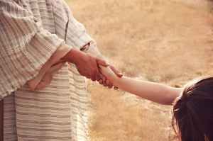 person holding kid hand