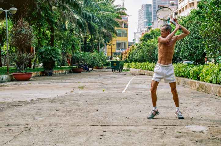 man about to strike using tennis racket