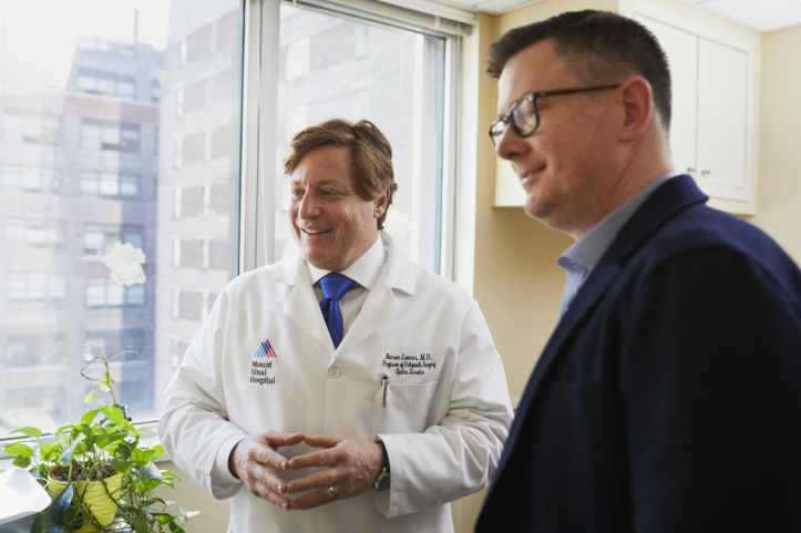 man next to doctor