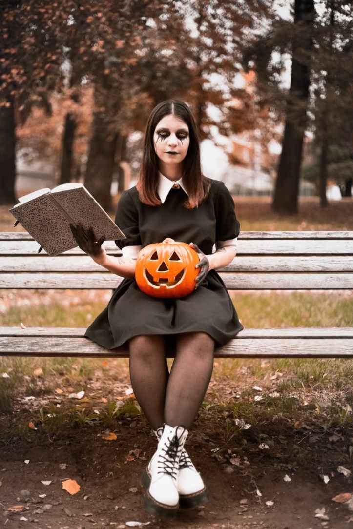 woman sitting on wooden bench