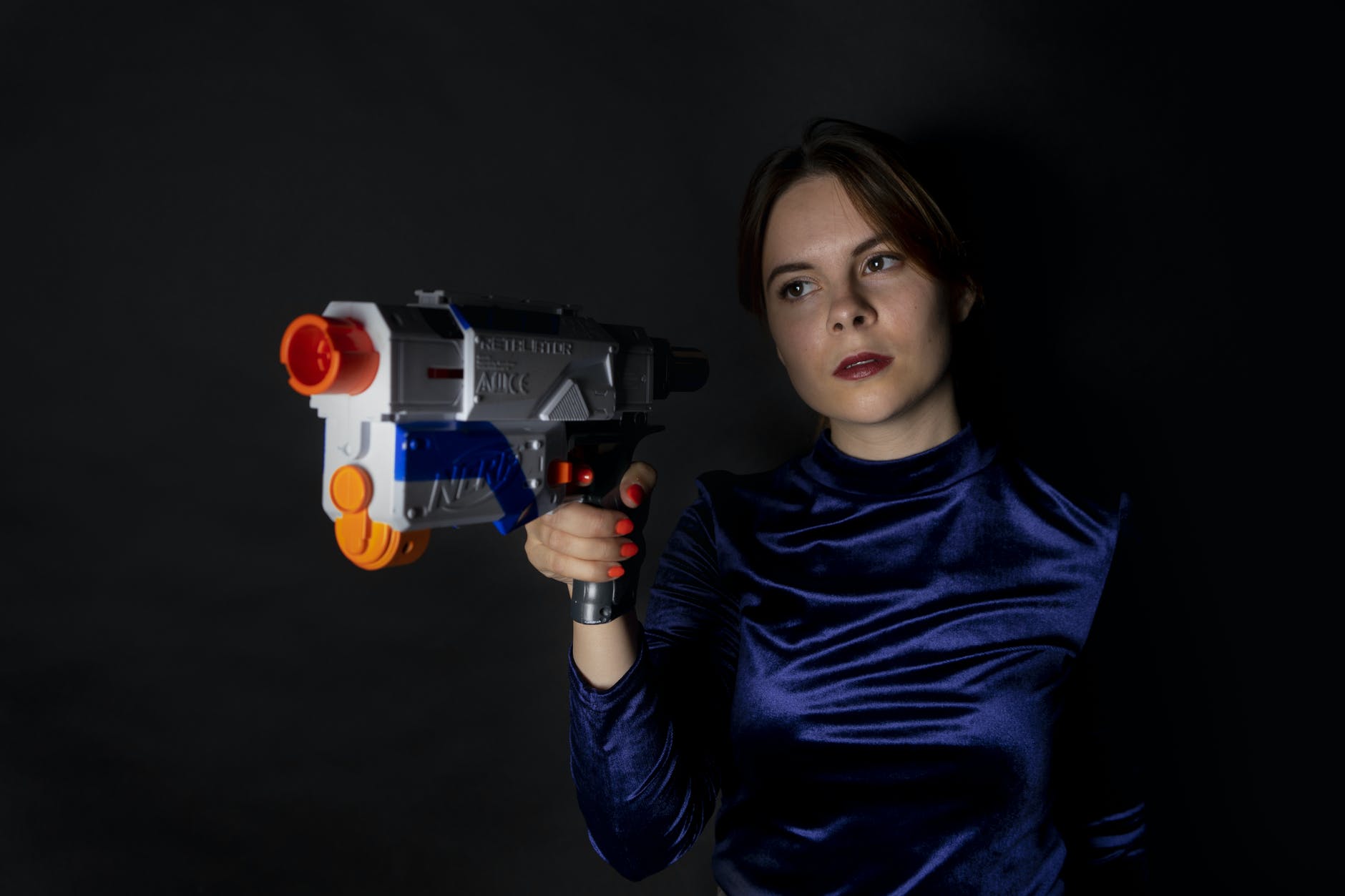 woman holding blue and white nerf gun