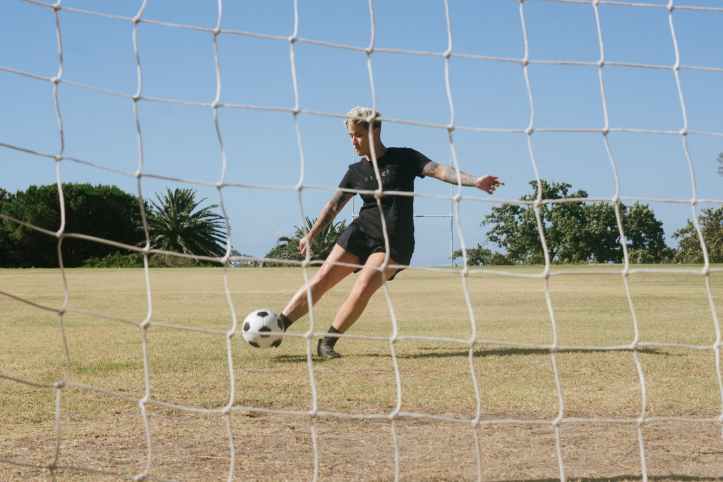 woman in black t shirt and playing soccer