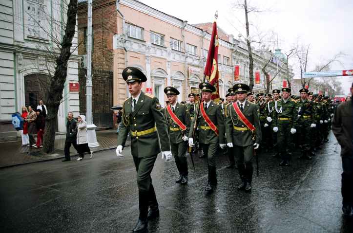 military personnel parades on road