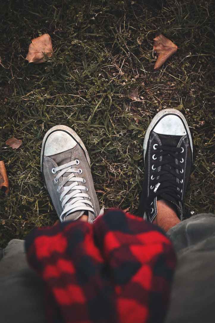 person wearing two different shoes
