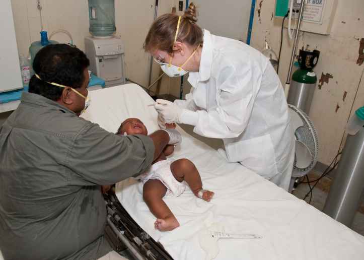 baby lying down on hospital bed getting a check up