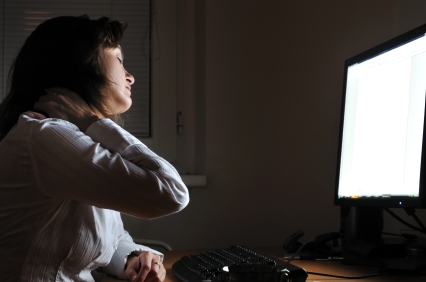 Business person working overtime with neck pain